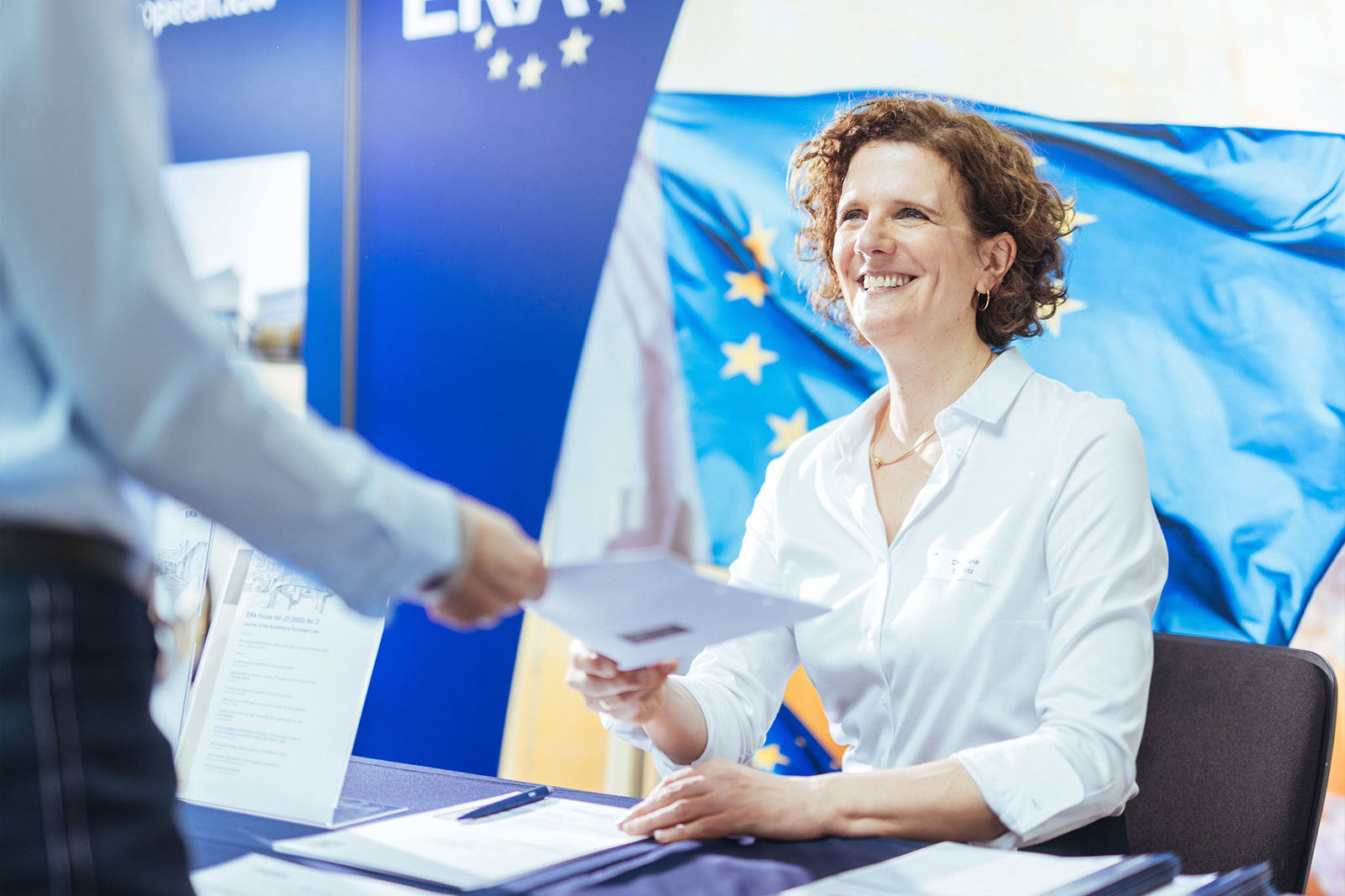 Friendly ERA staff member providing information documents – direct contact and support